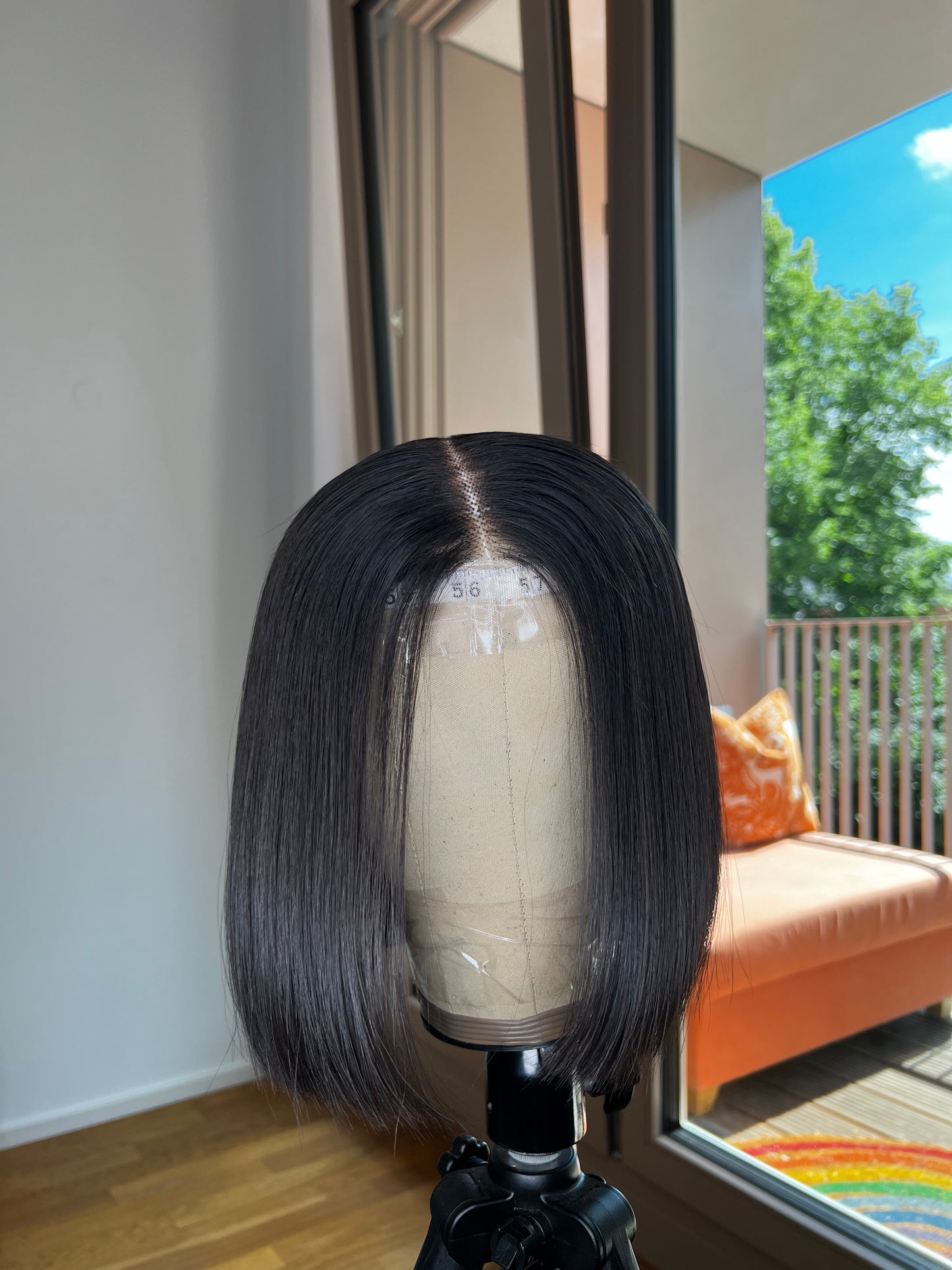 Blunt Cut Bob Wig on canvas mannequin head with a beautiful backdrop