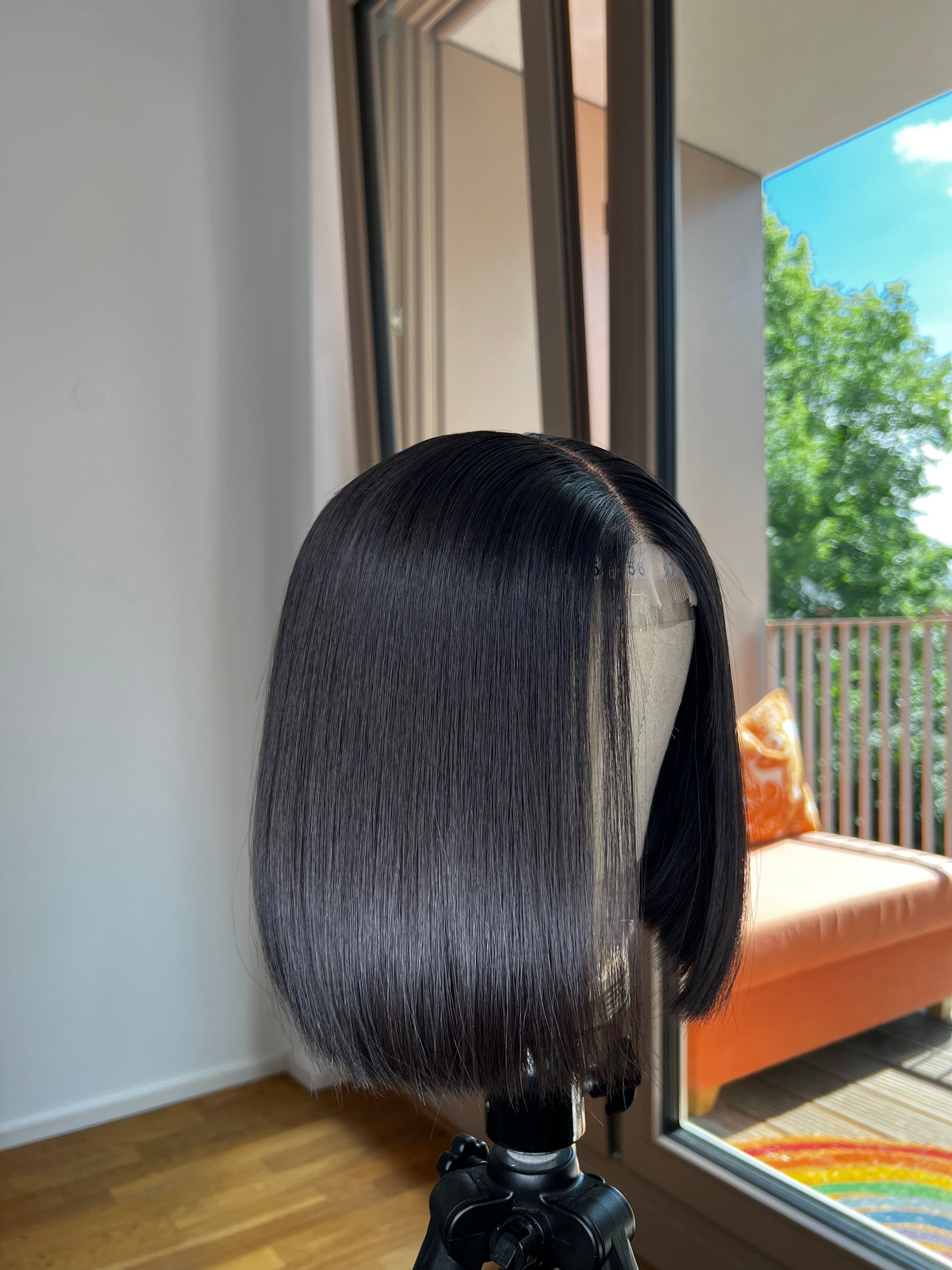 Blunt Cut Bob Wig on canvas mannequin head with a beautiful backdrop